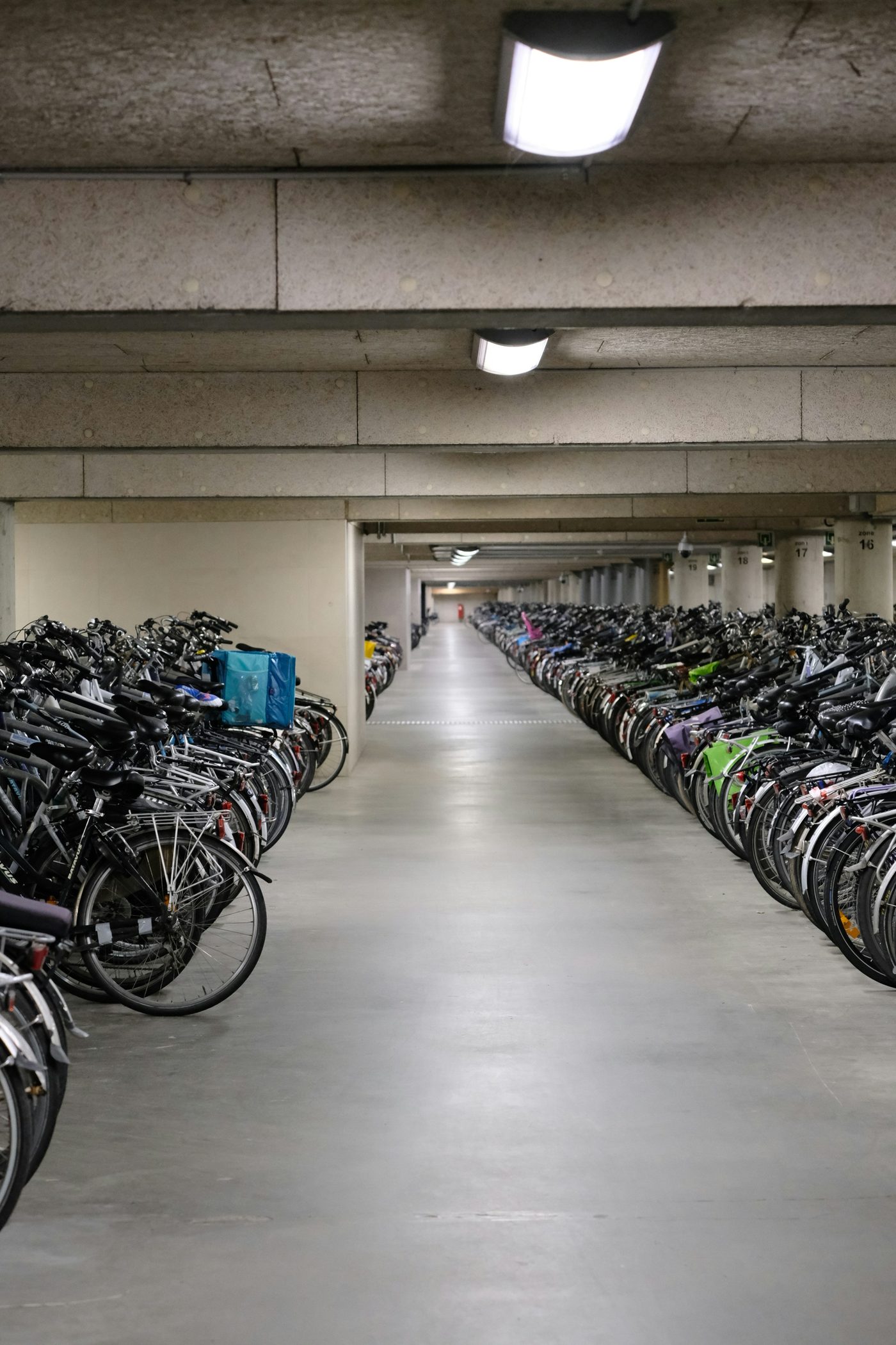 Long indoor bike-parking garage with many parked bikes