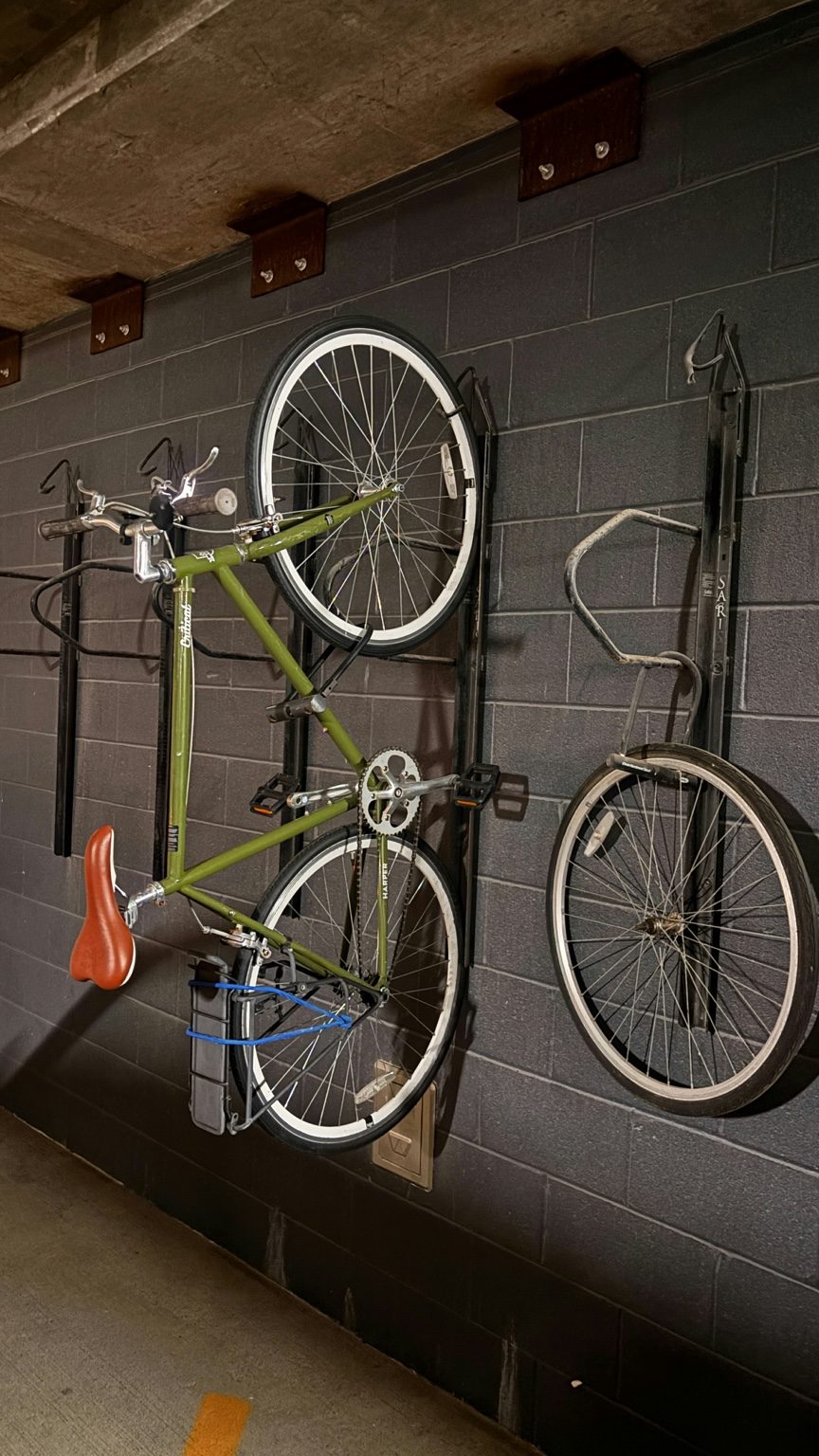 Bike stored vertically on an indoor wall rack