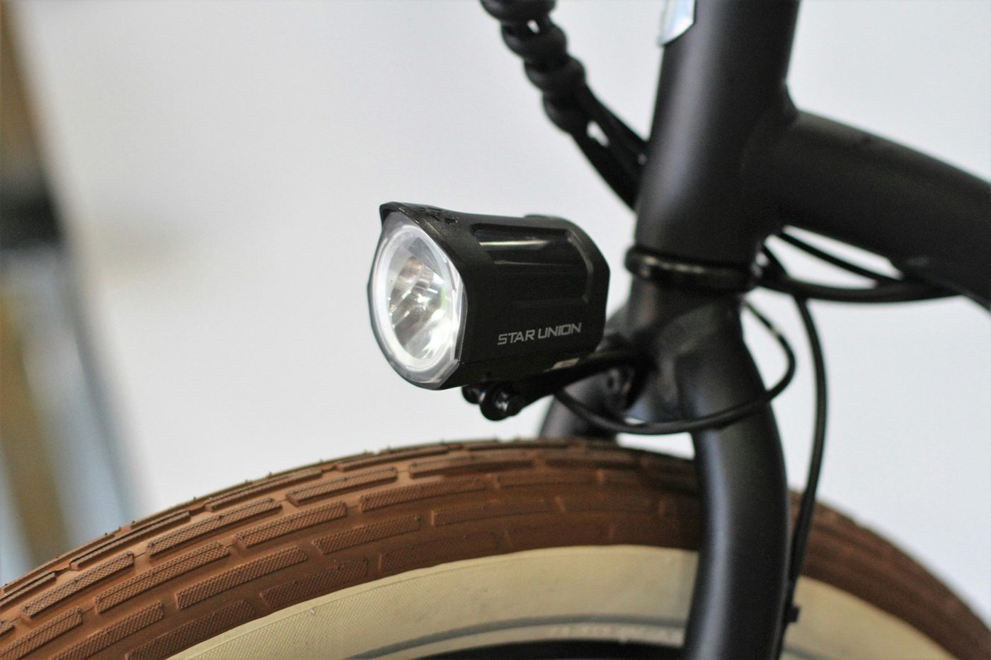 Integrated front light close-up mounted above a bicycle tire